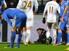 A ballboy (C) lies on the ground and reacts after a altercation with Chelsea's Belgium midfielder Eden Hazard  (Photo credit should read ANDREW YATES/AFP via Getty Images)