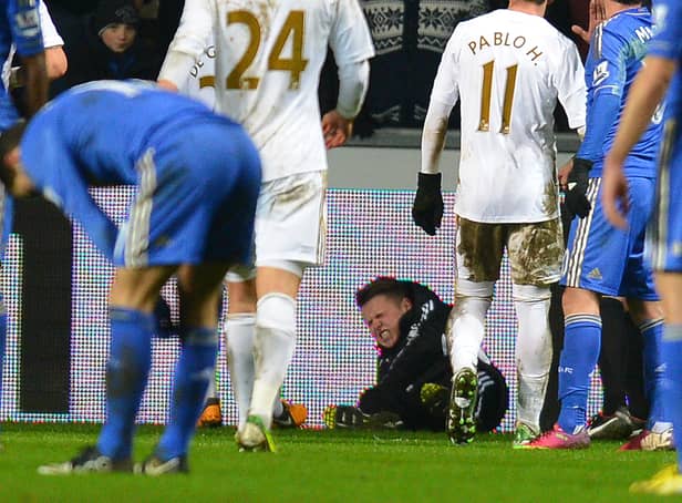 <p>A ballboy (C) lies on the ground and reacts after a altercation with Chelsea's Belgium midfielder Eden Hazard  (Photo credit should read ANDREW YATES/AFP via Getty Images)</p>