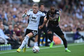 Jay Stansfield of Fulham is challenged by Rico Henry of Brentford during the Premier League match between Fulham FC and Brentford FC