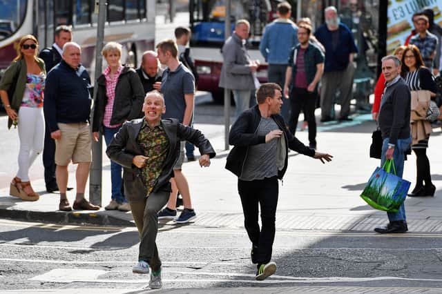 Actors Ewan McGregor and Ewan Bremner run on the set of the Trainspotting film sequel. Photo: Getty