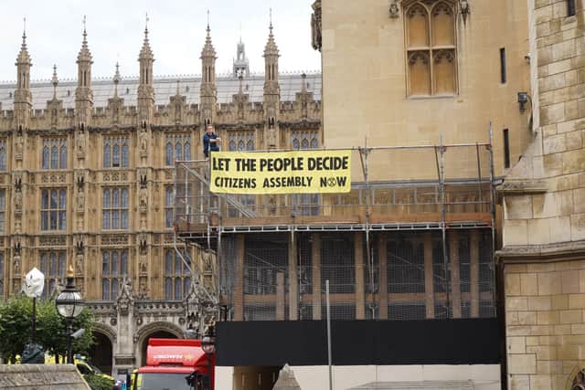 Banners were dropped across The Palace of Westminster building.