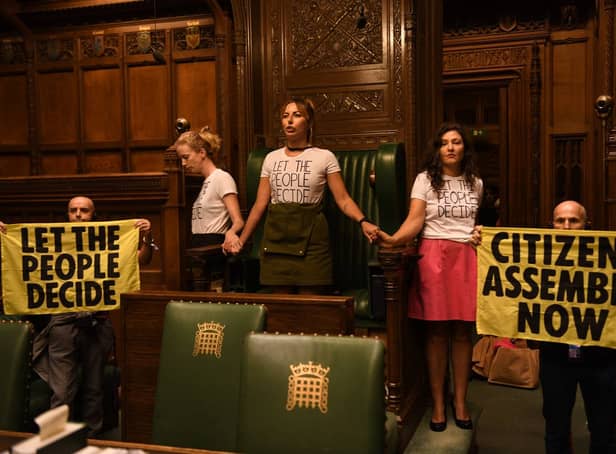 <p>Handout photo taken with permission from the twitter feed of Extinction Rebellion of protesters who have superglued themselves around the Speaker's chair in the House of Commons chamber, as they call for a Citizen's Assembly. Picture date: Friday September 2, 2022.</p>