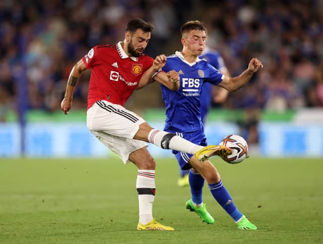 Bruno Fernandes of Manchester United is challenged by Luke Thomas of Leicester City