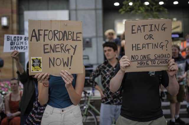 Protesters hold placards during a demonstration against rising energy prices outside Ofgem HQ. Photo: Getty