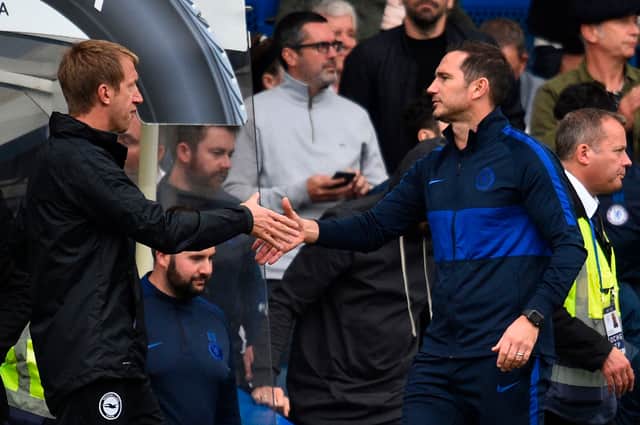 Chelsea’s English head coach Frank Lampard (R) shakes hands with Brighton’s English manager Graham Potter (L)   (Photo credit should read GLYN KIRK/AFP via Getty Images)