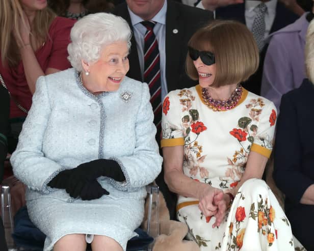 Queen Elizabeth II sits next to Vogue editor Anna Wintour at London Fashion Week in 2018. (Photo by Yui Mok - Pool/Getty Images)