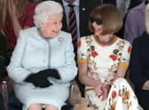 Queen Elizabeth II sits next to Vogue editor Anna Wintour at London Fashion Week in 2018. (Photo by Yui Mok - Pool/Getty Images)