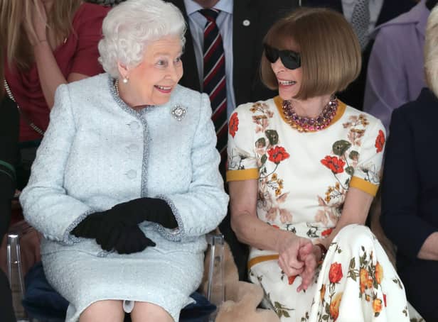 <p>Queen Elizabeth II sits next to Vogue editor Anna Wintour at London Fashion Week in 2018. (Photo by Yui Mok - Pool/Getty Images)</p>