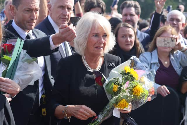 Camilla, Queen Consort views floral tributes to the late Queen Elizabeth II outside Buckingham Palace. Photo: Getty