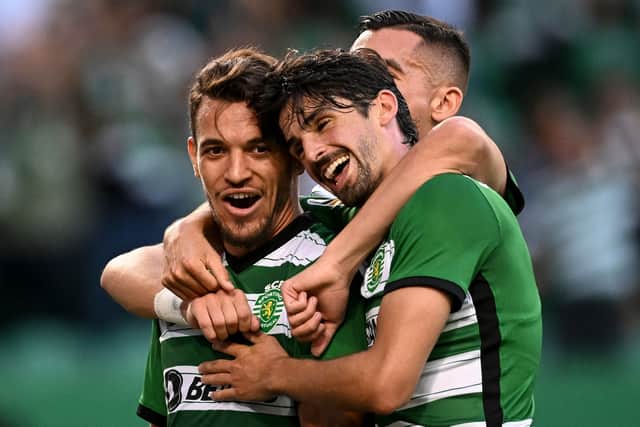 Sporting’s Portuguese midfielder Pedro Goncalves celebrates with his teammate Sporting’s Portuguese forward Francisco Trincao (C) and Sporting’s Greek midielder Sotiris Alexandropoulos (R)