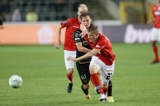 Anderlecht’s Frederik Kristian Arnstad (L) fights for the ball with  Silkeborg’s Anders Klynge  during their UEFA Conference League football match
