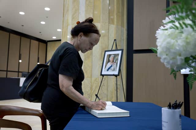 Yamile Reyes signs a condolence book for Queen Elizabeth II at the British Consulate in Brickell on September 12, 2022 in Miami, Florida