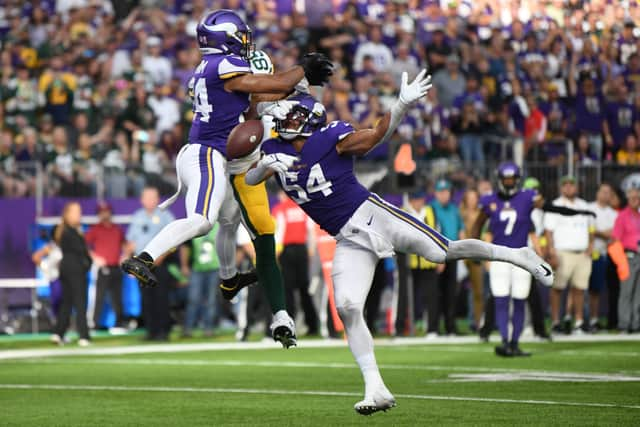 Camryn Bynum #24 and Eric Kendricks #54 of the Minnesota Vikings break up a pass