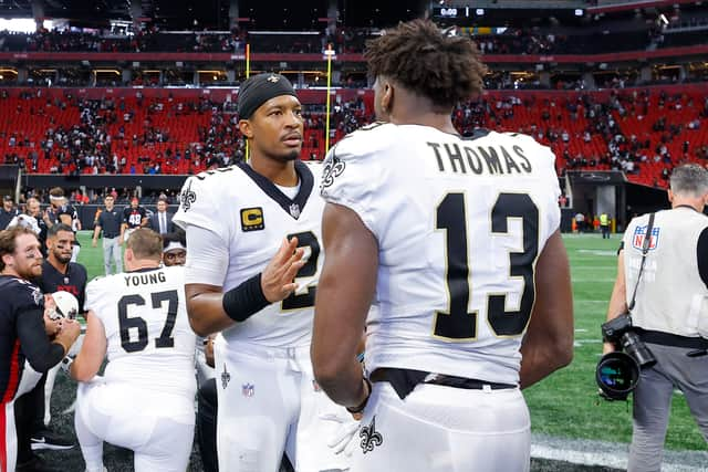 Jameis Winston #2 of the New Orleans Saints talks with Michael Thomas #13