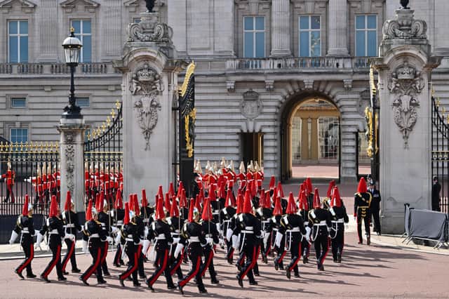 Military are seen entering the gates of Buckingham Palace ahead of the procession. Photo: Getty