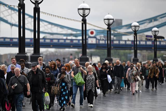 Members of the public stand in the queue on the South Bank of the River Thames. Photo: Getty
