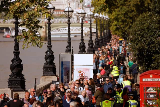 Members of the public queue on The South Bank as they wait in line to pay their respects. Photo: Getty