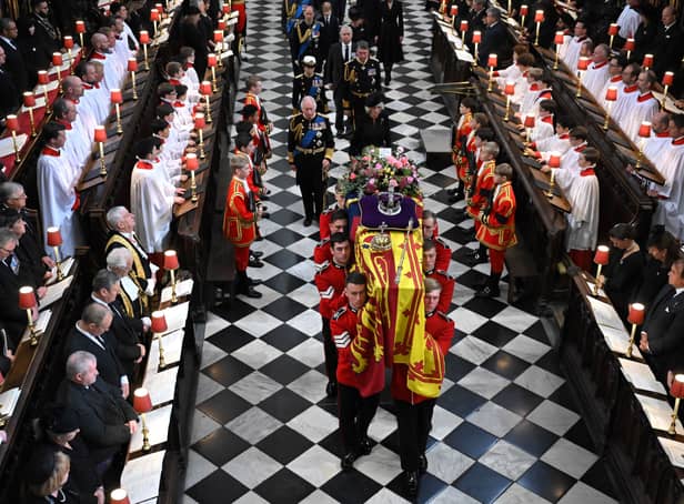 Soldiers of The Queen’s Company of the Grenadier Guards carry the coffin of Queen Elizabeth II