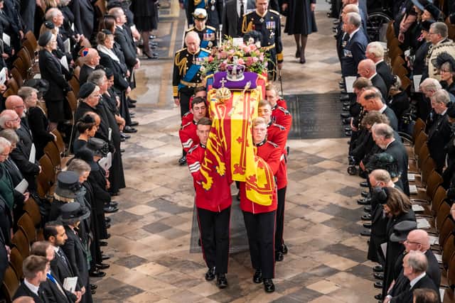King Charles III follow behind the coffin of Queen Elizabeth II, draped in the Royal Standard with the Imperial State Crown and the Sovereign’s orb and sceptre, at Westminster Abbey on September 19, 2022
