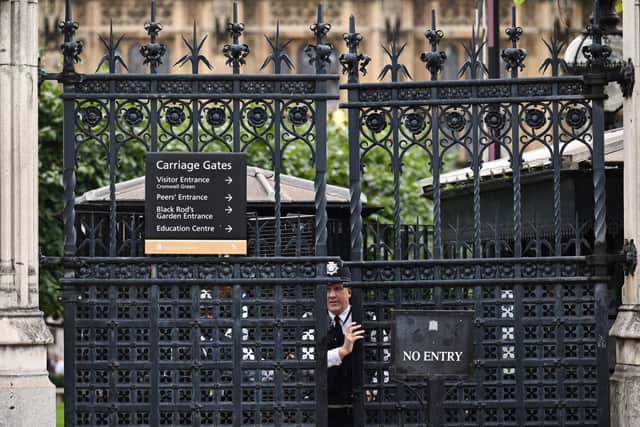An officer of the London Metropolitan Police closes a gate at the Palace of Westminster. Photo: Getty