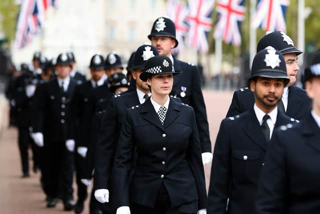 Met Police officers are seen walking in formation down The Mall. Photo: Getty