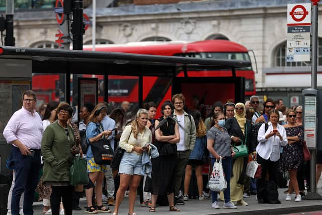 Passengers queue for busses outside Victoria Station London during strike action. Photo: Getty
