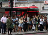 Passengers queue for busses outside Victoria Station London during strike action. Photo: Getty