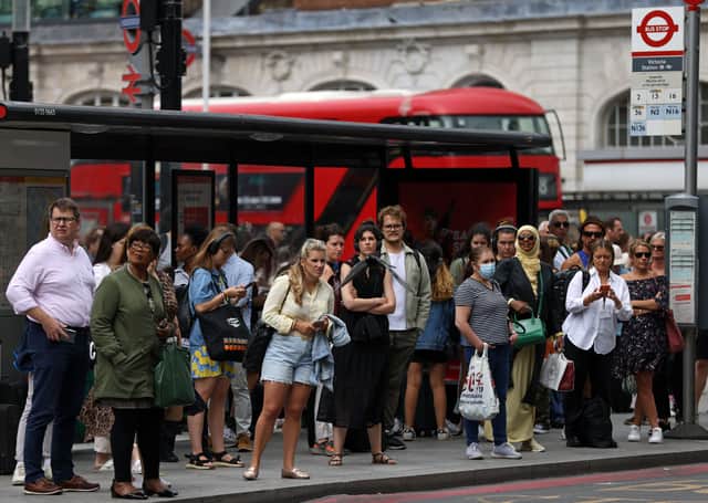 Passengers queue for busses outside Victoria Station London during strike action. Photo: Getty