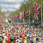 Runners fill the road after crossing the finish Line near Buckingham Palace during the 2009 London Marathon