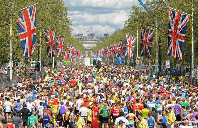 Runners fill the road after crossing the finish Line near Buckingham Palace during the 2009 London Marathon