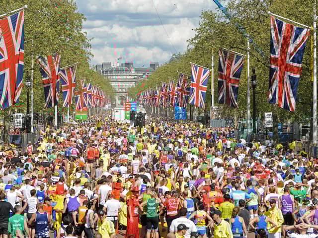 Runners fill the road after crossing the finish Line near Buckingham Palace during the 2009 London Marathon