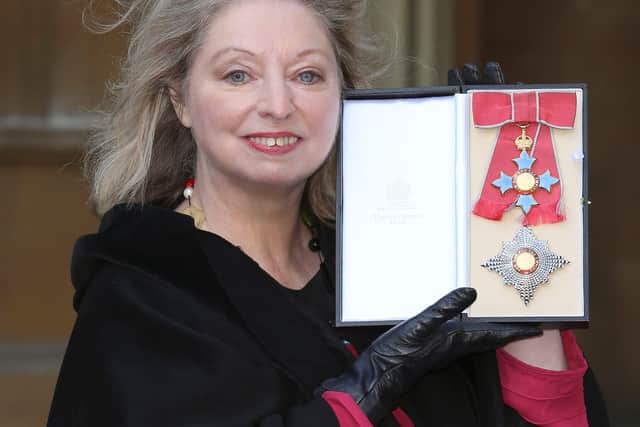 Dame Hilary Mantel holds her Dame Commander of the British Empire medal for services to literature. Photo: Getty
