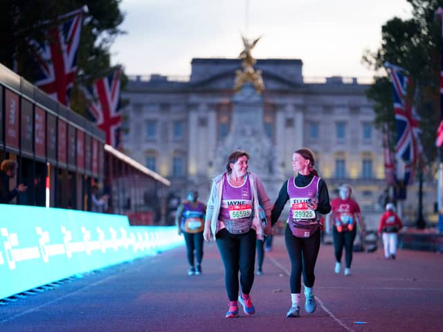 Back of the pack runners on The Mall heading towards the finish line at the end of the 2021 Virgin Money London Marathon