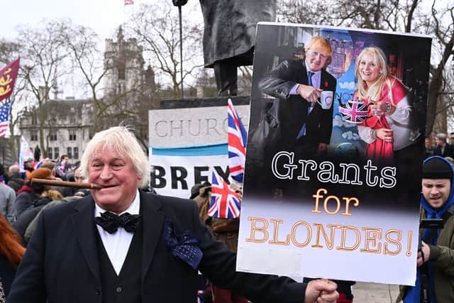 Ms Arcuri and Mr Johnson’s links sparked criticism, including from this anti-Brexit protester holding up a placard in 2020. Photo: Getty