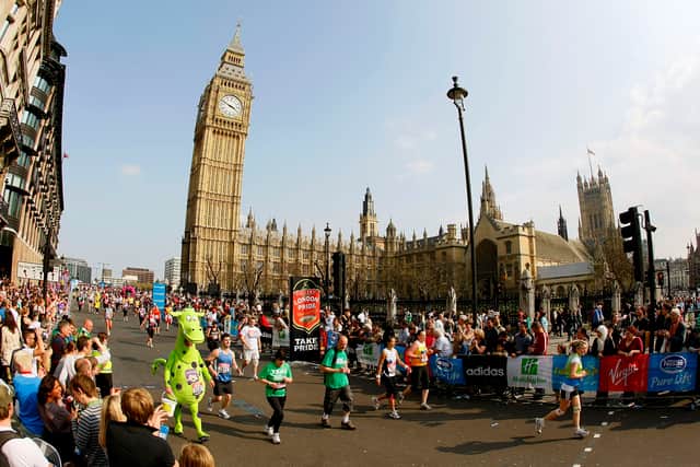 Competitors run past Big Ben in Westminster as they near the end of the London Marathon