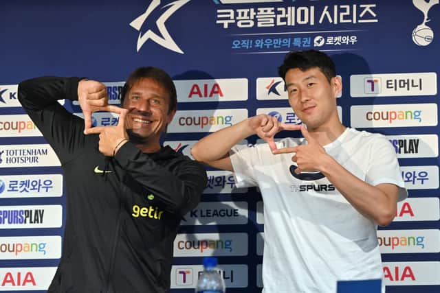 Tottenham Hotspur’s South Korean striker Son Heung-min (R) and head coach Antonio Conte (L) pose for a photo during a pre-match  (Photo by JUNG YEON-JE/AFP via Getty Images)