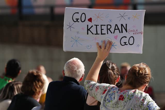 A spectator holds up a sign reading “Go Kieren Go” in the mass marathon. Photo: Getty