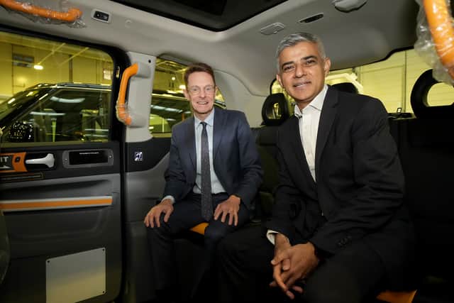 Mayor of London Sadiq Khan, right, and West Midlands mayor Andy Street sit in the back of an electric taxi. Photo: Getty