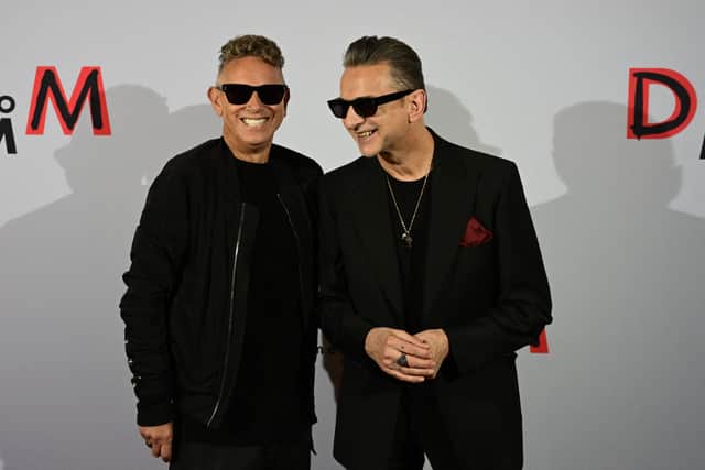 Members of the English electronic music band Depeche Mode, Martin Gore (L) and Dave Gahan, smile ahead of a press conference in Berlin