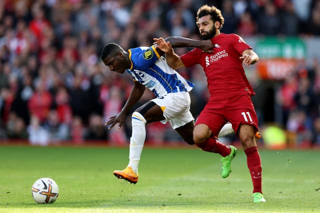 Mohamed Salah of Liverpool is challenged by Moises Caicedo of Brighton & Hove Albion during the Premier League match between Liverpool FC and Brighton & Hove Albion