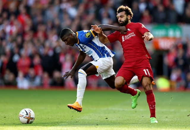 Mohamed Salah of Liverpool is challenged by Moises Caicedo of Brighton & Hove Albion during the Premier League match between Liverpool FC and Brighton & Hove Albion