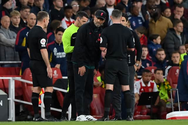 Referee Michael Oliver speaks to Jurgen Klopp, Manager of Liverpool and  Mikel Arteta, Manager of Arsenal after an on field incident during the Premier League match between Arsenal FC and Liverpool FC