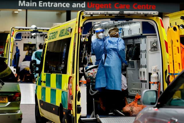 Paramedics prepare to remove a patient from an ambulance parked outside Guy’s Hospital. Photo: Getty