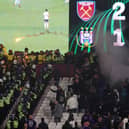 Police are seen separating West Ham United and Anderlecht fans as flares are thrown  (Photo by Alex Pantling/Getty Images)