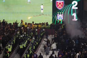 Police are seen separating West Ham United and Anderlecht fans as flares are thrown  (Photo by Alex Pantling/Getty Images)