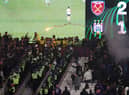 Police are seen separating West Ham United and Anderlecht fans as flares are thrown  (Photo by Alex Pantling/Getty Images)