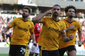 Wolverhampton Wanderers' Portuguese midfielder Ruben Neves (C) celebrates after scoring the opening goal (Photo by GEOFF CADDICK/AFP via Getty Images)