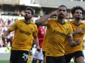 Wolverhampton Wanderers' Portuguese midfielder Ruben Neves (C) celebrates after scoring the opening goal (Photo by GEOFF CADDICK/AFP via Getty Images)