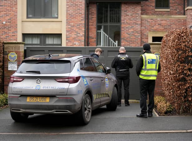 Police officers standing outside Mason Greenwood’s house in February 2022.