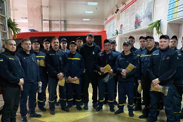 Firefighters in Zaporizhzhia receiving protective gloves